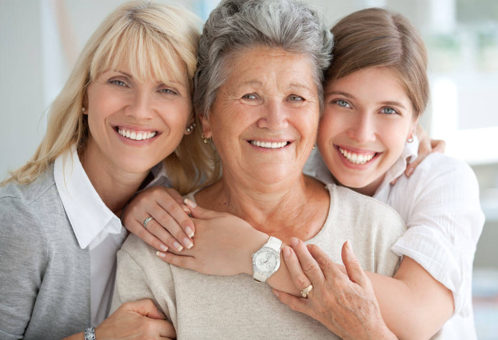 3 generations of women smile together, one with a Snap-On Smile in San Antonio, TX