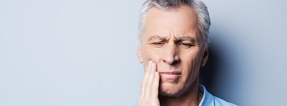 an older man with mouth pain