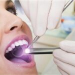 woman undergoing an oral cancer screening at the dentist office