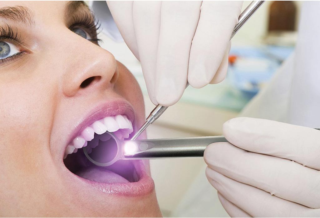 woman undergoing an oral cancer screening at the dentist office