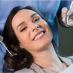 young woman smiles after a dental cleaning and check up