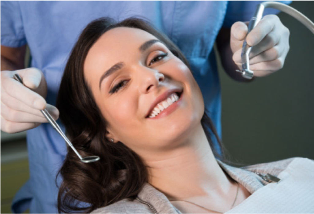 young woman smiles after a dental cleaning and check up