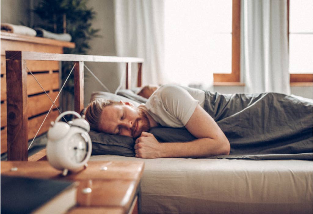 bearded man sleeping on his side