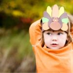 young girl shows off thanksgiving turkey headdress