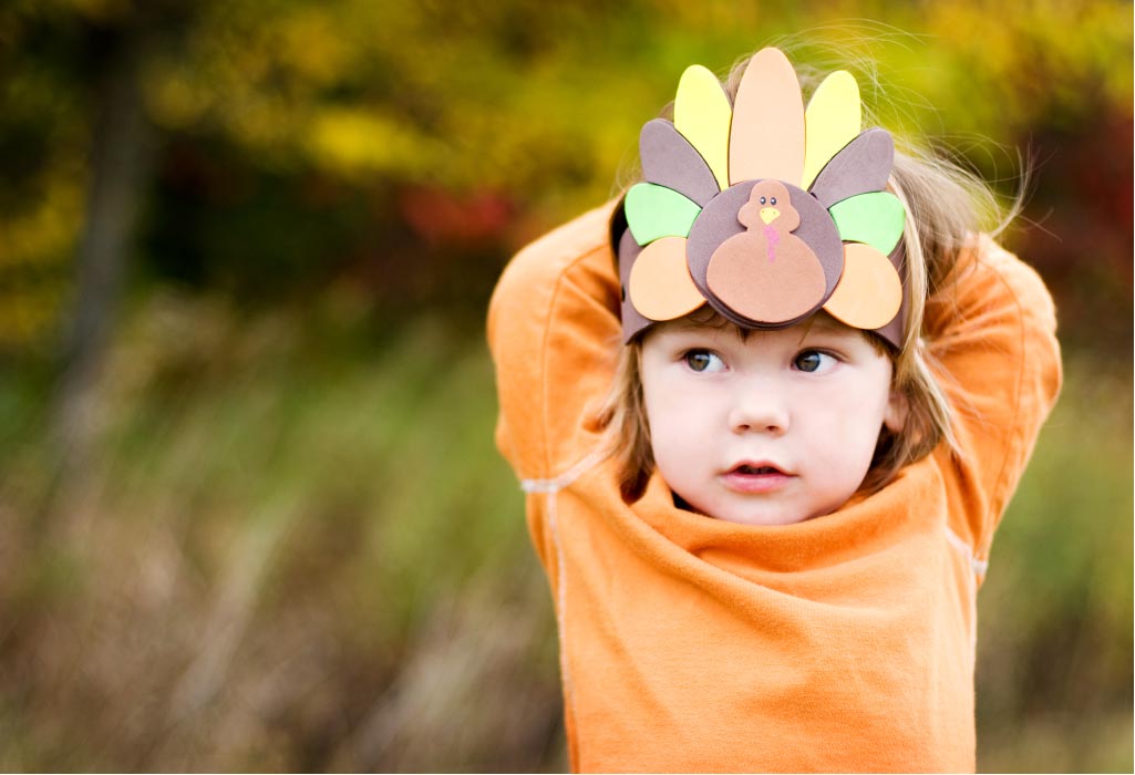 young girl shows off thanksgiving turkey headdress