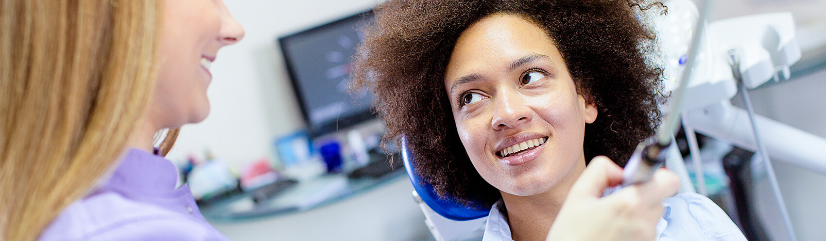 woman about to have her mouth examined by her dentist