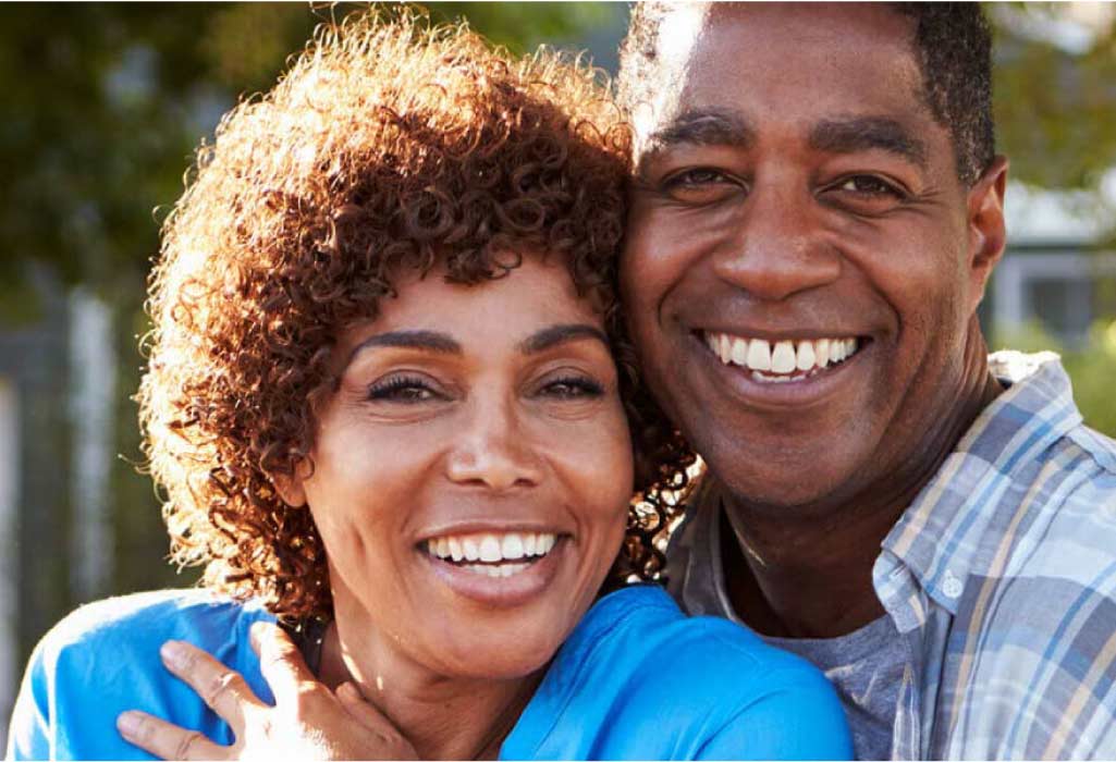 a couple smile showing off their porcelain veneers