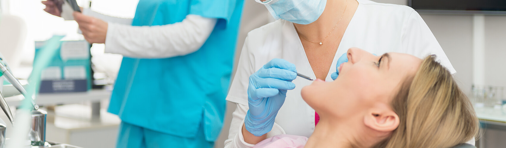 woman having her teeth examined by a dentist