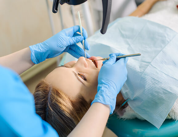 woman having her teeth examined by a dentist