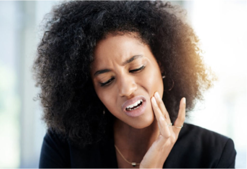 woman holds her jaw with severe tooth pain