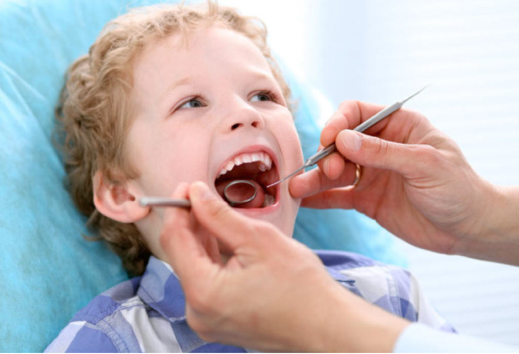 young boy getting a dental exam