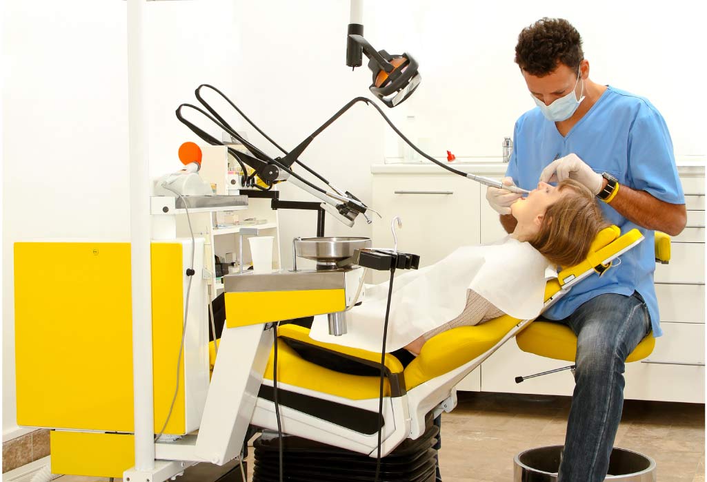 dental patient in the dentist chair getting a cavity filled by the dentist