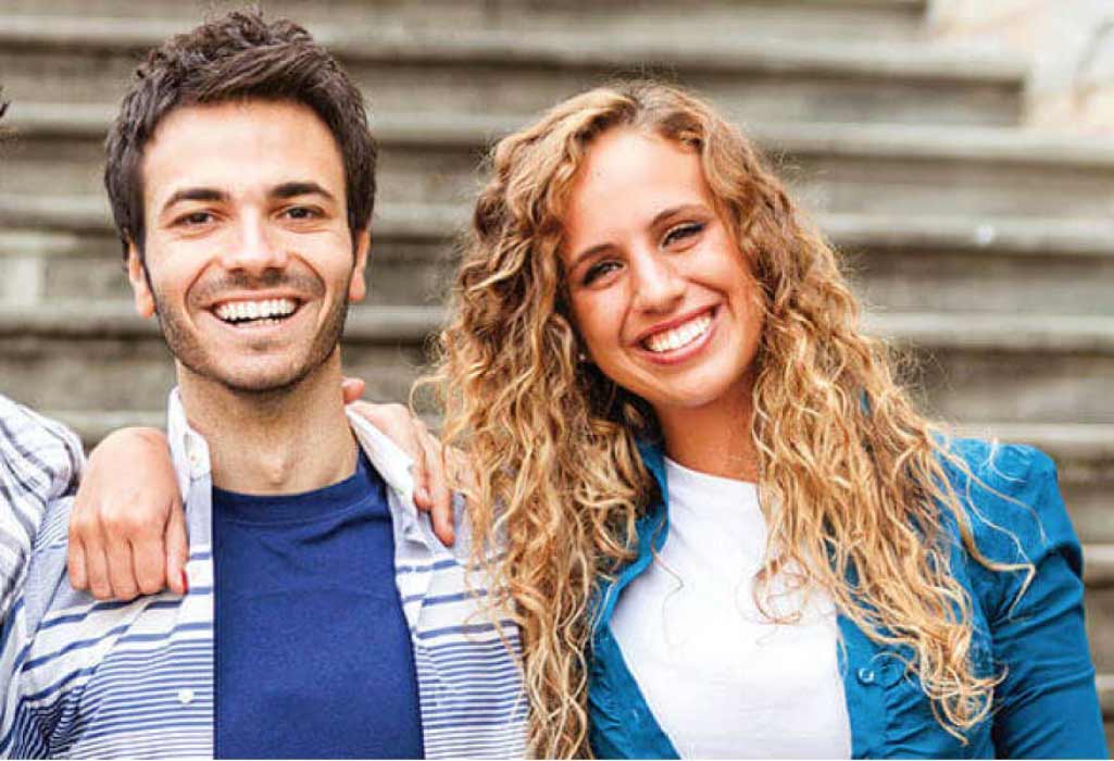 young couple smile showing off their professional teeth whitening results