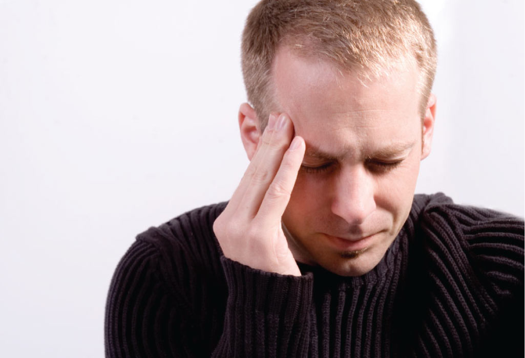 man holding his head with a tooth pain headache