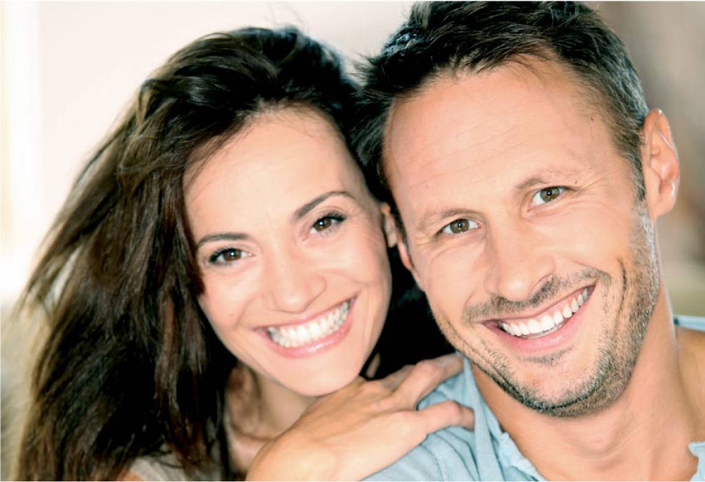 young couple smile after learning about snap on smile vs veneers