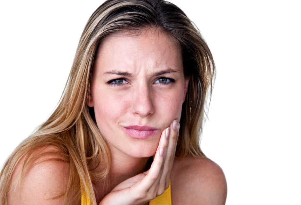 woman holds her jaw in pain with a tooth infection