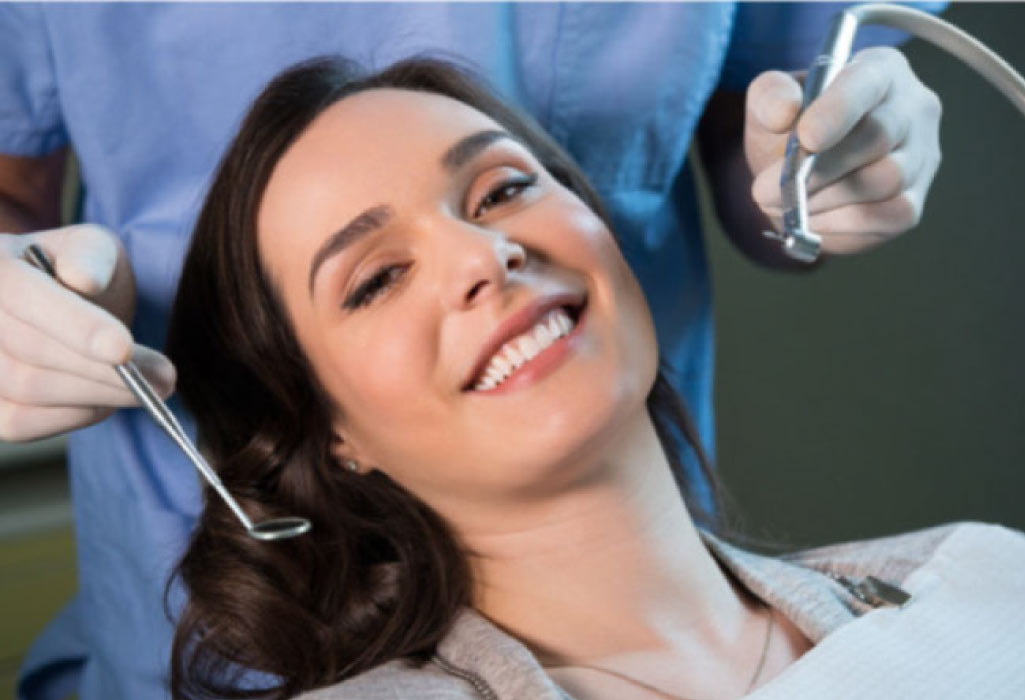 young woman in the dentist chair getting an exam and cleaning