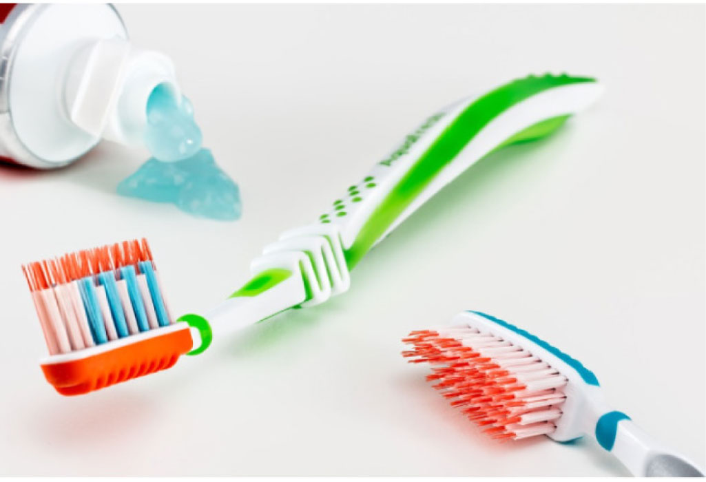 two toothbrushes by toothpaste