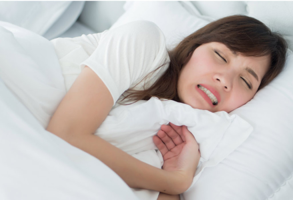 woman grinds her teeth while sleeping