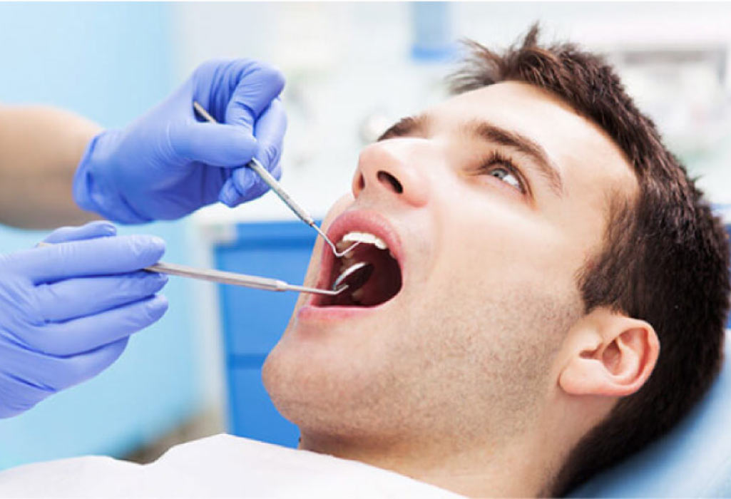 man gets an oral cancer screening at the dentist 