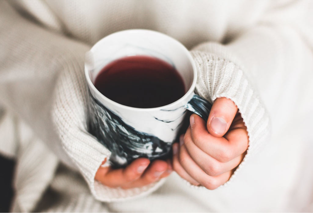 hands holding a mug of tea