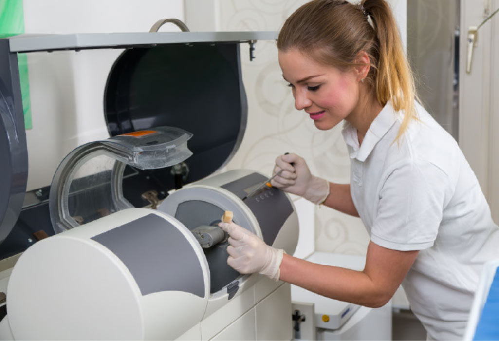 female dental tech using modern technology