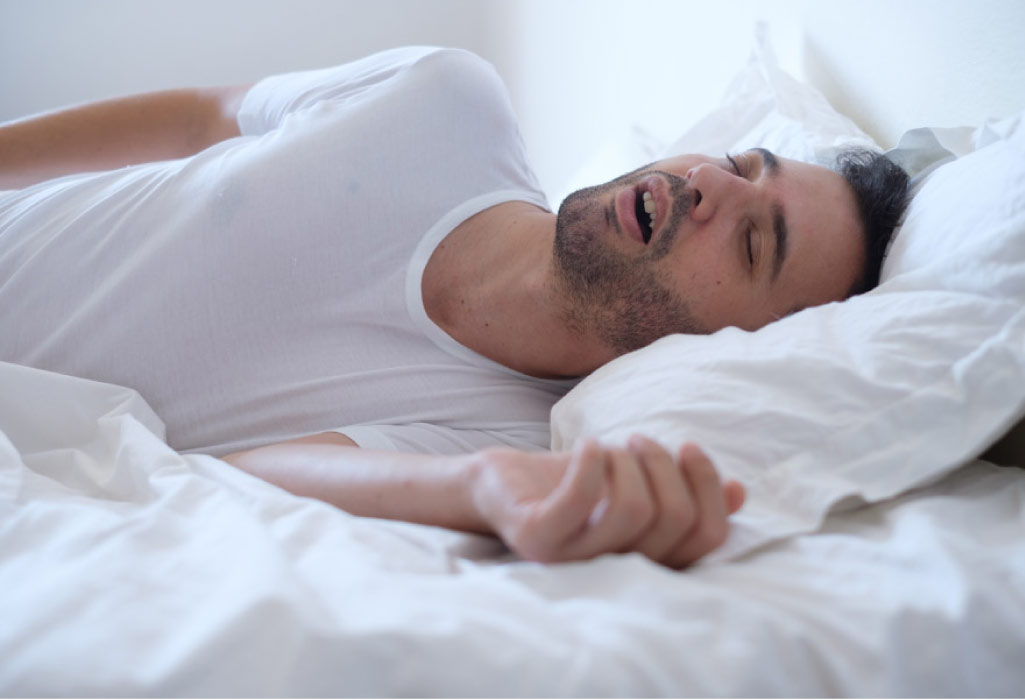 sleeping man snores because of sleep apnea