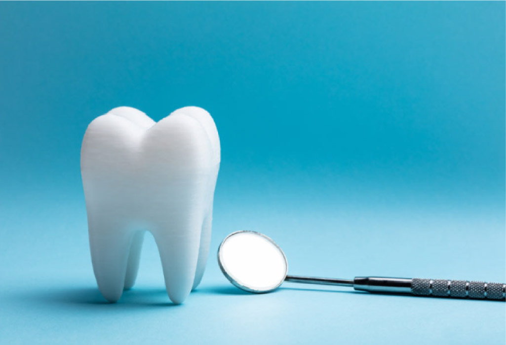 tooth sitting next to a small mirror