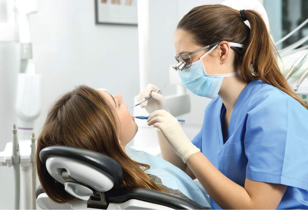 female patient gets checked for a loose dental implant