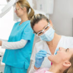 woman in the dentist chair gets a dental implant checkup