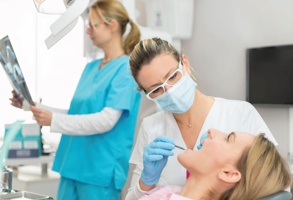 woman in the dentist chair gets a dental implant checkup