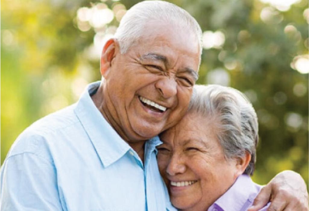 senior couple hug and smile after learning a denture options