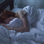 sleeping woman hugs the sheets