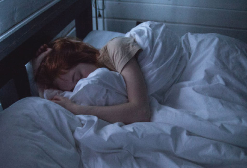 sleeping woman hugs the sheets