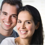 young couple smile showing off their recent fluoride treatments