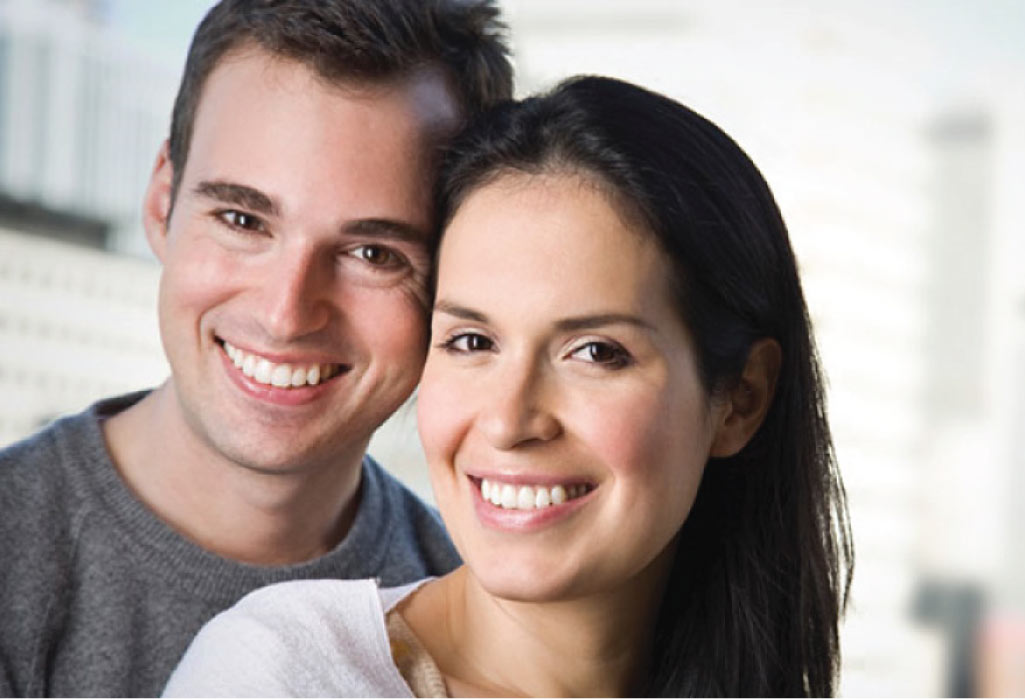 young couple smile showing off their recent fluoride treatments